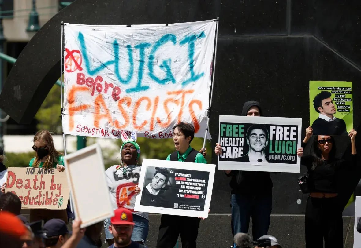protesters hold signs