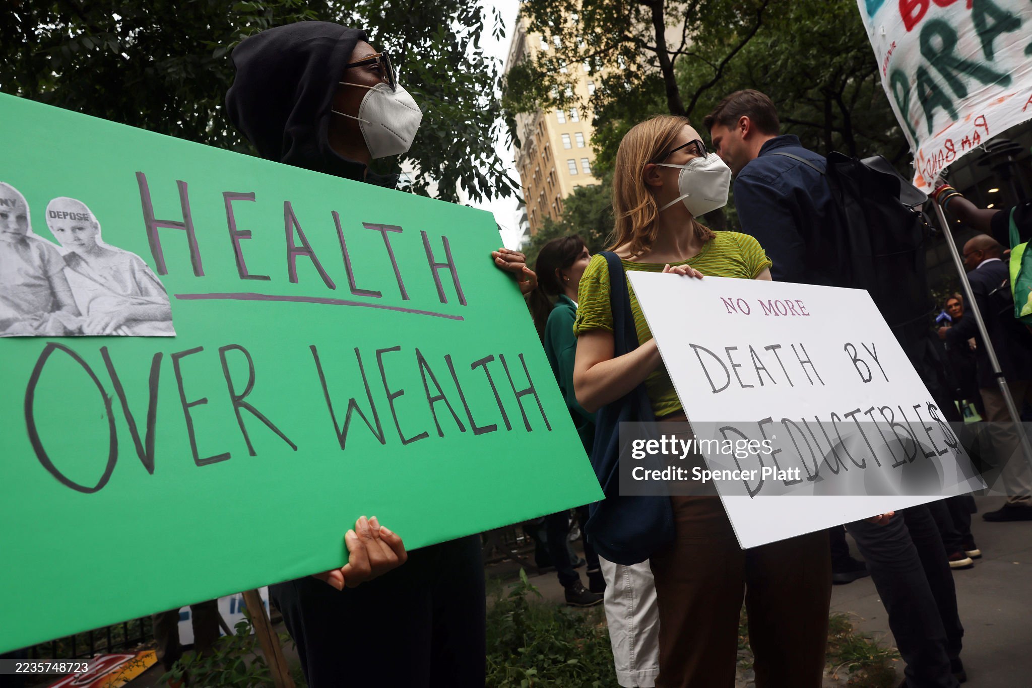 Protesters hold signs